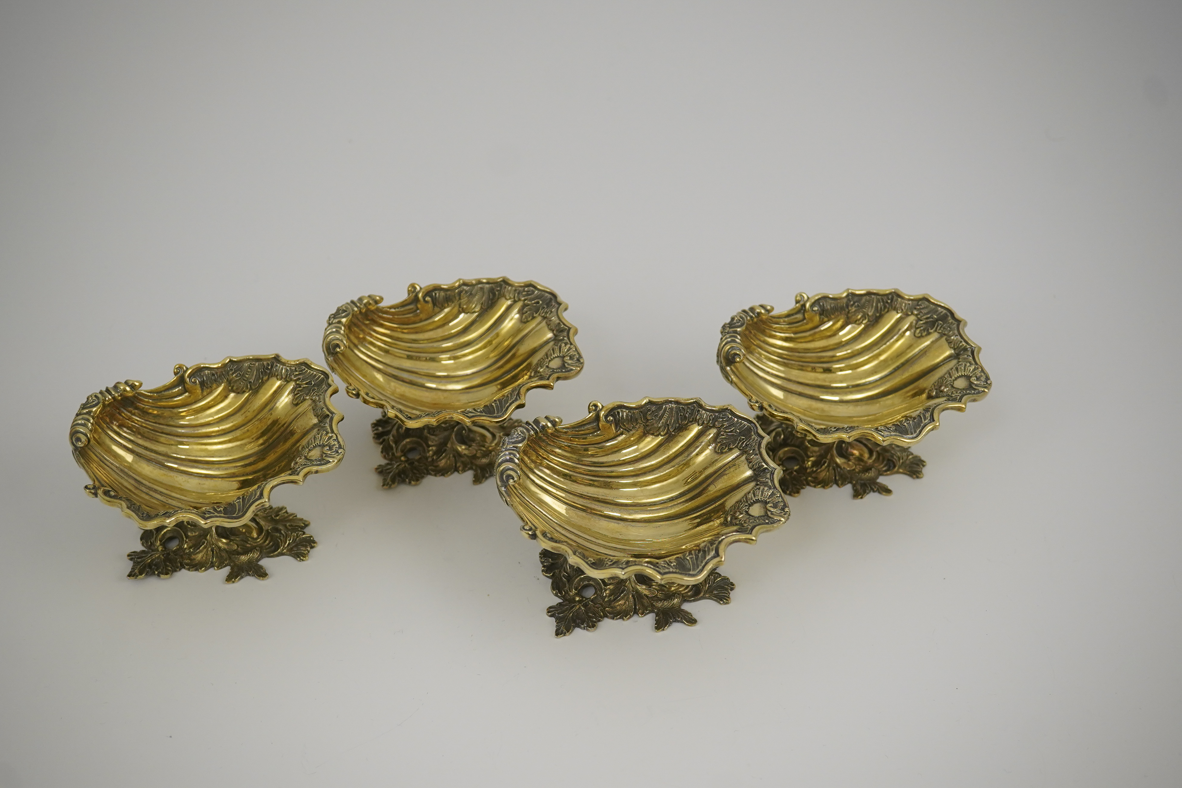 A set of Elizabeth II Victorian style silver gilt pedestal shell salts, by Asprey & Co Ltd